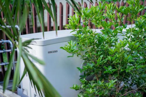 a group of plants in white planters next to a fence at Wellness Smart Suites in Bolzano