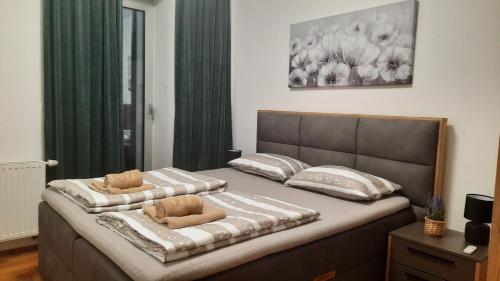 a bedroom with a bed with two pillows on it at Apartman Tena in Vukovar