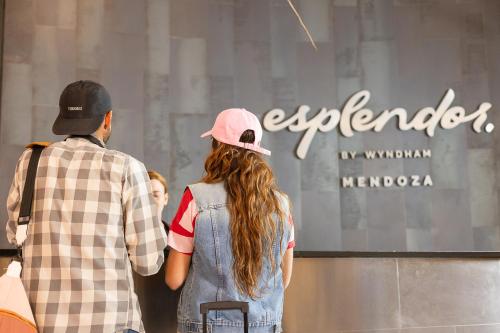 a man and a woman looking at a store window at Esplendor by Wyndham Mendoza in Mendoza