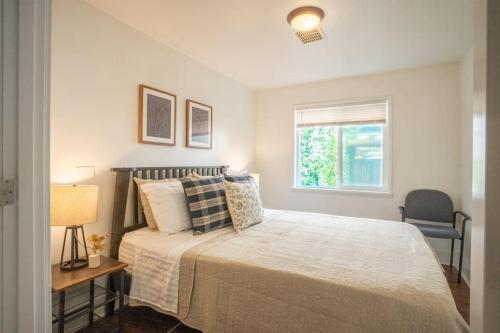a bedroom with a large bed and a window at Seaside Serenity 1 BR Apt with balcony near Alki in Seattle