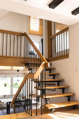 a staircase in a house with a table and chairs at Auszeit Altenhorst, Gartenferienwohnung in Schalksmühle