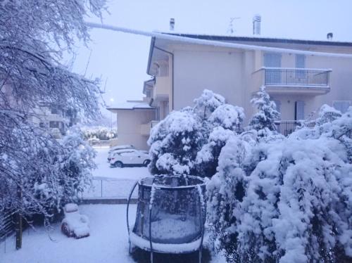 a yard covered in snow in front of a house at Valle Rubicone in Gatteo
