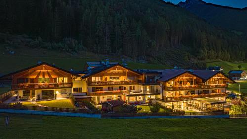 an aerial view of a building with a mountain at Martinshof berg herz hotel in San Giovanni in Val Aurina