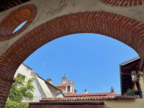 a brick archway with a building in the background at S a p p h i r e H o M e - Rivarolo DesignApartment in Rivarolo Canavese