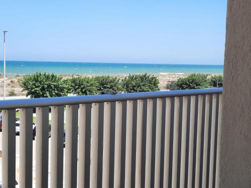 a balcony with a white fence and the ocean at Almar Relax in Daimuz