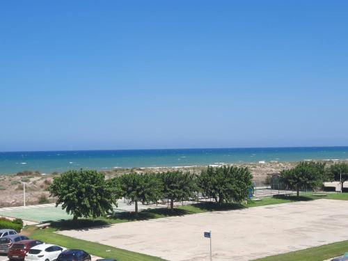 a parking lot with trees and the ocean in the background at Almar Relax in Daimuz