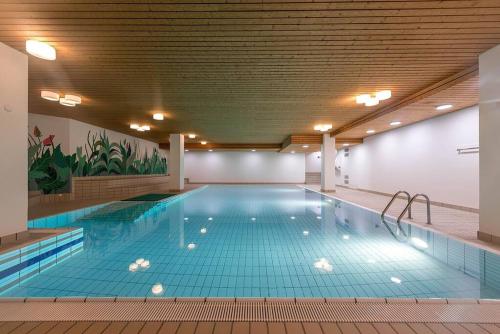 a large indoor swimming pool with a large blue pool at Studio centralissimo a St. Moritz in St. Moritz