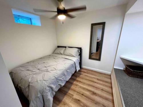 a bedroom with a bed and a ceiling fan at Modern Studio in Norwalk in Norwalk