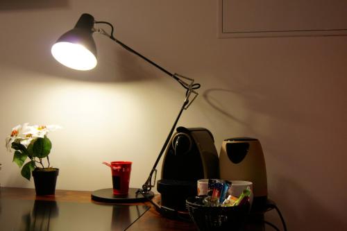 a lamp sitting on top of a desk next to a computer at Ferme Sainte Marie in Rémilly