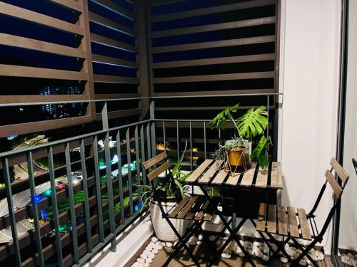 a balcony with a table with plants on it at Selayang 18 Residences (with Wifi 300Mbps) in Batu Caves