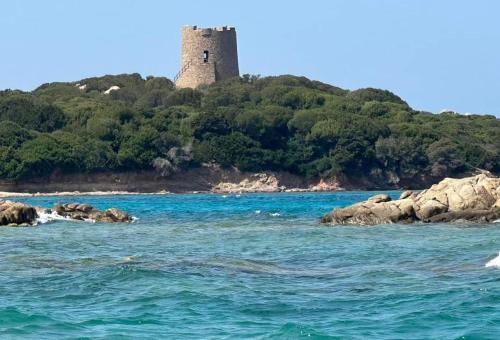 a castle on an island in the water at Surf House Mirice in Vignola Mare