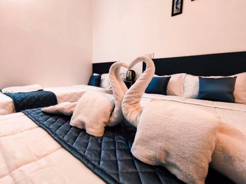 a bedroom with a bed with towel swans on it at DE LUMA Beach View in Puducherry