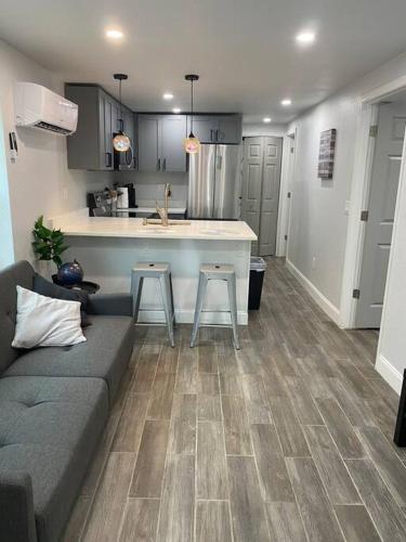 a living room with a couch and a kitchen at Betterplace 2-Bedooms Walk to Armature Works and Downtown Tampa in Tampa