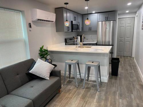 a living room with a couch and a kitchen at Betterplace 2-Bedooms Walk to Armature Works and Downtown Tampa in Tampa