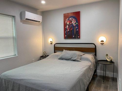 a bedroom with a bed and a painting on the wall at Betterplace 2-Bedooms Walk to Armature Works and Downtown Tampa in Tampa