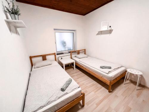 a bedroom with two beds and a window at 3 Apartments in 1 location in Prague