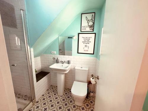 a bathroom with a toilet and a sink at DUPLEX IN TARIFA'S OLD TOWN in Tarifa