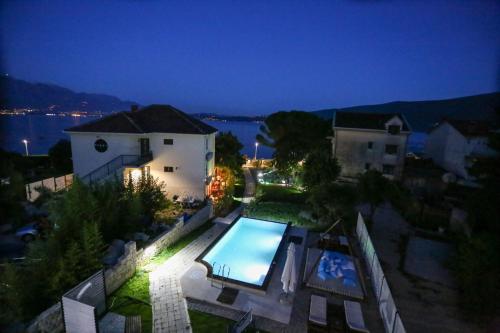 an aerial view of a house with a swimming pool at Apartments Cukovic in Herceg-Novi