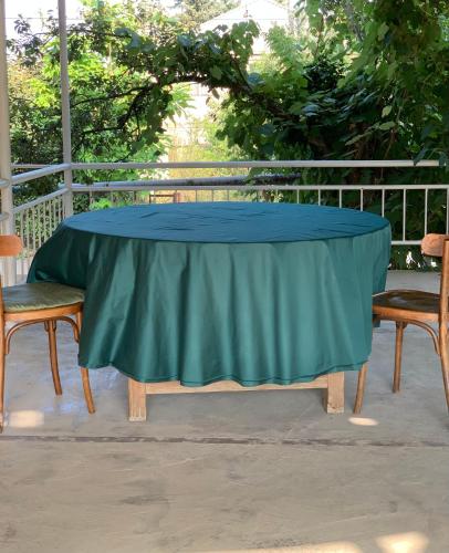 a table with a blue table cloth on a patio at DendroBak GuestHouse in Stepʼanavan