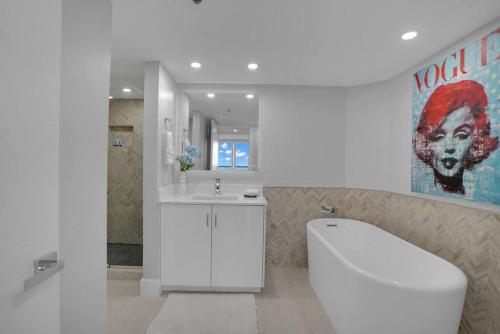 a bathroom with a white toilet and a sink at Cloud Nine! Direct Water Views of Bay & Ocean! in Miami