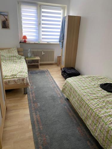 - une chambre avec 2 lits et un tapis dans l'établissement Fewo Schöneck, à Schoneck