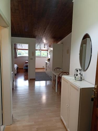 a kitchen and living room with a wooden ceiling at Tenuta PARAVANO in Povoletto