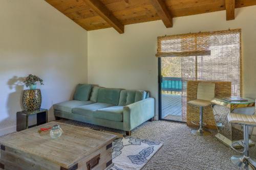 a living room with a couch and a table at Pet-Friendly Coarsegold Vacation Rental with Deck! in Coarsegold