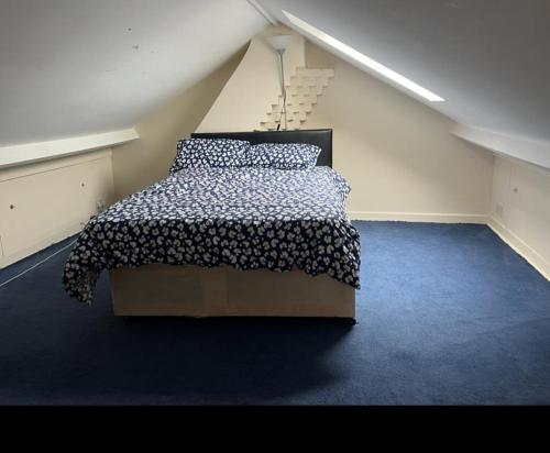 a bedroom with a bed in a attic at Kenilworth Gardens in Kent