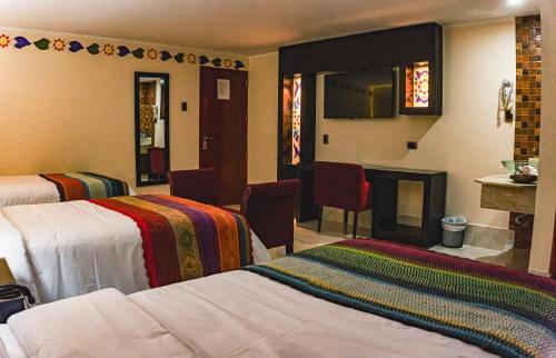 a hotel room with two beds and a fireplace at Altipacha Ayacucho Hotel in Ayacucho