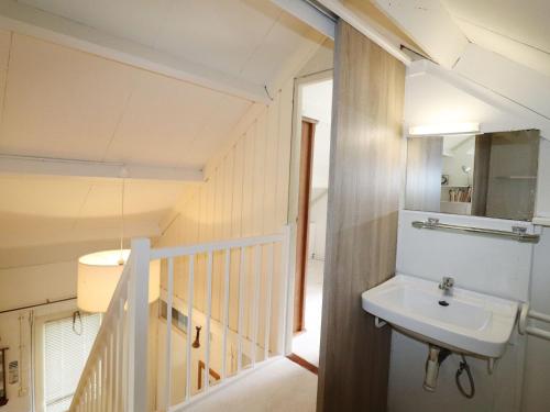 een badkamer met een wastafel en een trap bij House in Appelscha on the edge of the forest in Appelscha