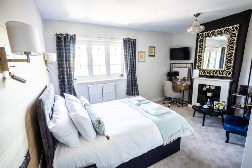 a bedroom with a large bed and a mirror at Woodborough Hall in Woodborough