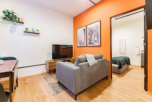 a living room with a couch and a table at Mariano Escobedo Apartments by VH in Mexico City