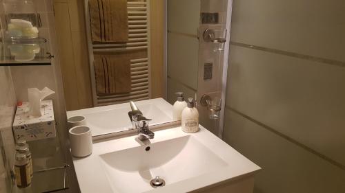 a bathroom with a white sink and a mirror at "La Coustille" Chambres et Table d'Hôtes in Saint-Léger-les-Mélèzes