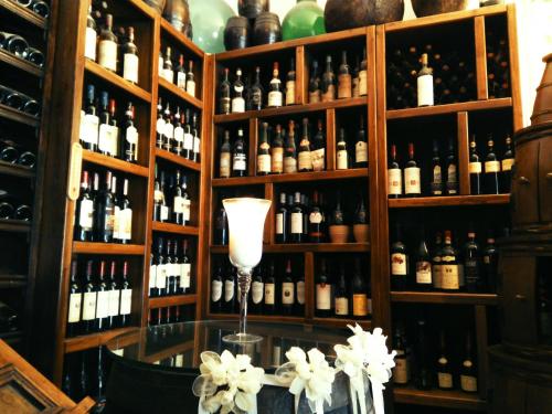 a room filled with lots of bottles of wine at Hotel Villa Sonia in Taormina