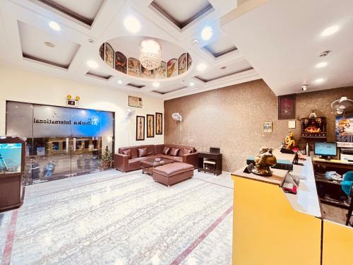 a large lobby with a waiting room with a tv at Ashoka International Hotel - Karol Bagh New Delhi in New Delhi
