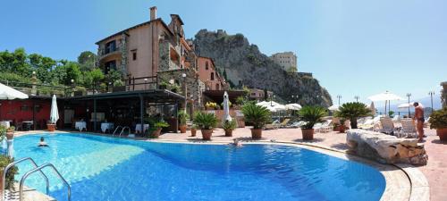 a large swimming pool in front of a hotel at Hotel Villa Sonia in Taormina
