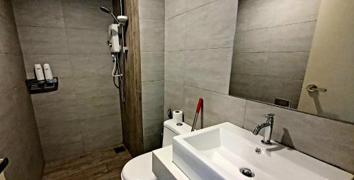 a bathroom with a sink and a mirror and a toilet at Arte+ Jalan Ampang MY in Kuala Lumpur