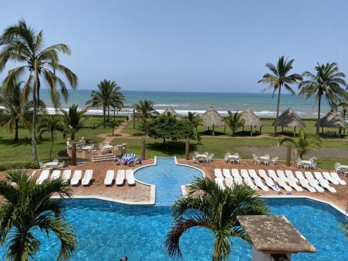 a view of a resort with a swimming pool and the beach at Hotel Torre Molino in Monte Gordo