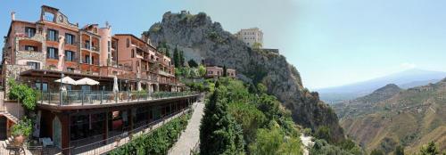 a building on the side of a mountain at Hotel Villa Sonia in Taormina