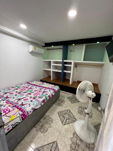a small room with a bed and a fan at Apartamento amoblado CARTAGENA in Cartagena de Indias