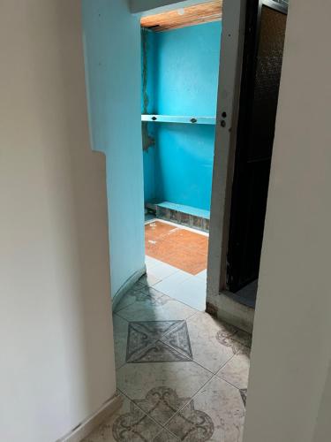 an open door to a room with a blue wall at Apartamento amoblado CARTAGENA in Cartagena de Indias