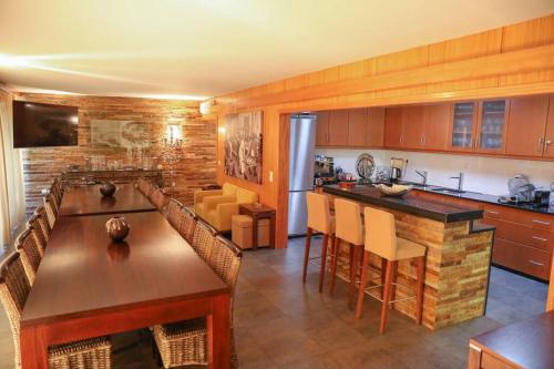 a kitchen with a large island in a room at Quintinha das Laranjeiras in Santa Cruz do Douro