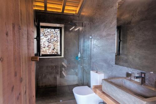 a bathroom with a sink and a toilet and a window at Lava Homes in Santo Amaro