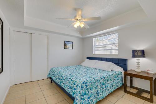 a bedroom with a bed and a ceiling fan at Florida Condo with Intracoastal Waterway Views! in Clearwater Beach