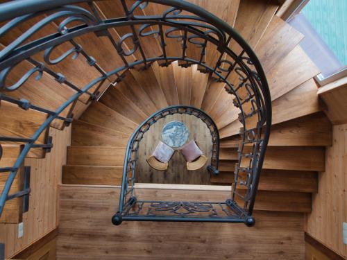 a spiral staircase in a house with a pair of shoes at Nikol Guest House in Bukovel