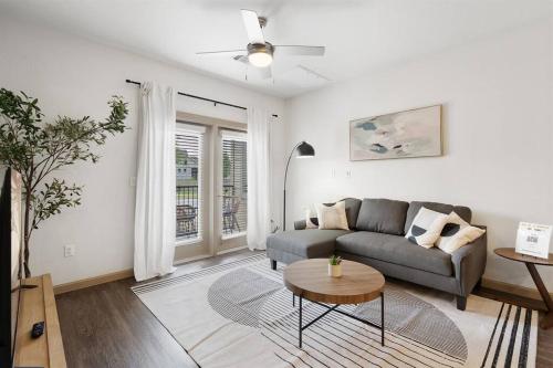a living room with a couch and a table at Luxe 2B/2B Getaway - Pool, Gym, Garage, Pet Wash in Leander