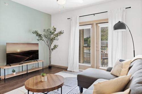 a living room with a couch and a table at Luxe 2B/2B Getaway - Pool, Gym, Garage, Pet Wash in Leander