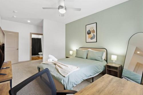 a bedroom with a bed and a table and a chair at Luxe 2B/2B Getaway - Pool, Gym, Garage, Pet Wash in Leander