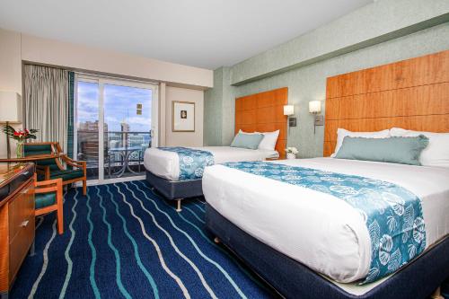 a hotel room with two beds and a balcony at Ocean Views from balcony Walk to Beach and Mall 3024 in Honolulu
