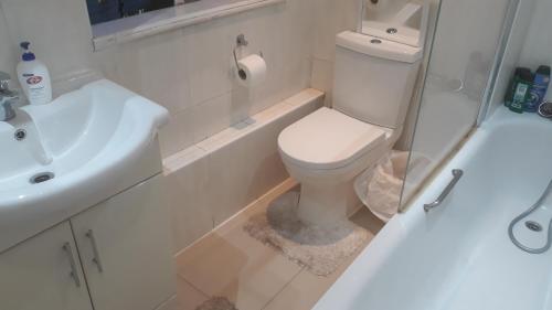 a bathroom with a white toilet and a sink at 2 dable bedroom (65 westbourn court) in London